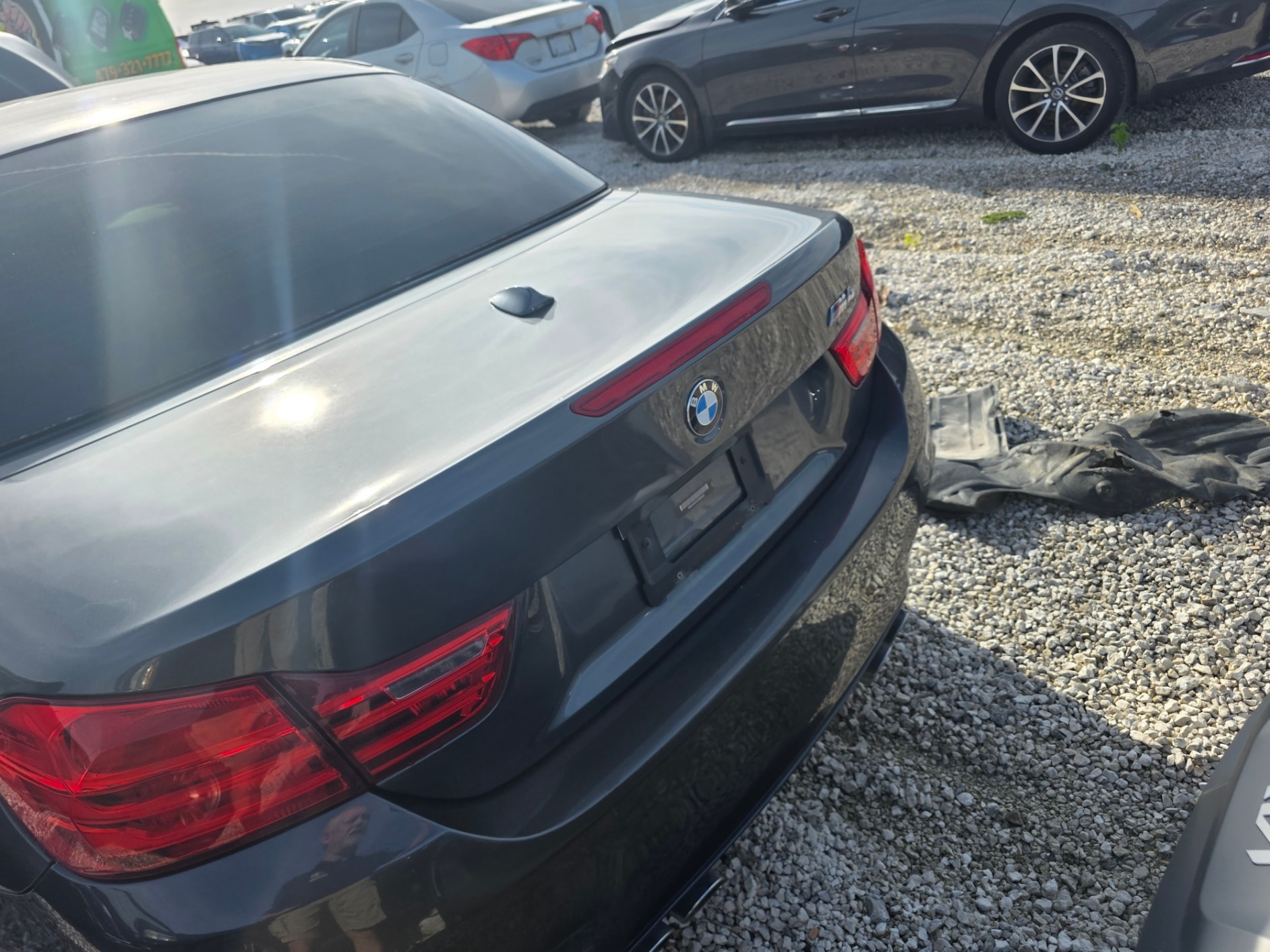 BMW sedans in gravel lot