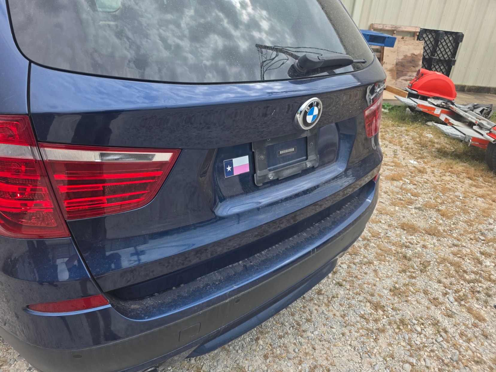 Black BMW SUV at salvage yard