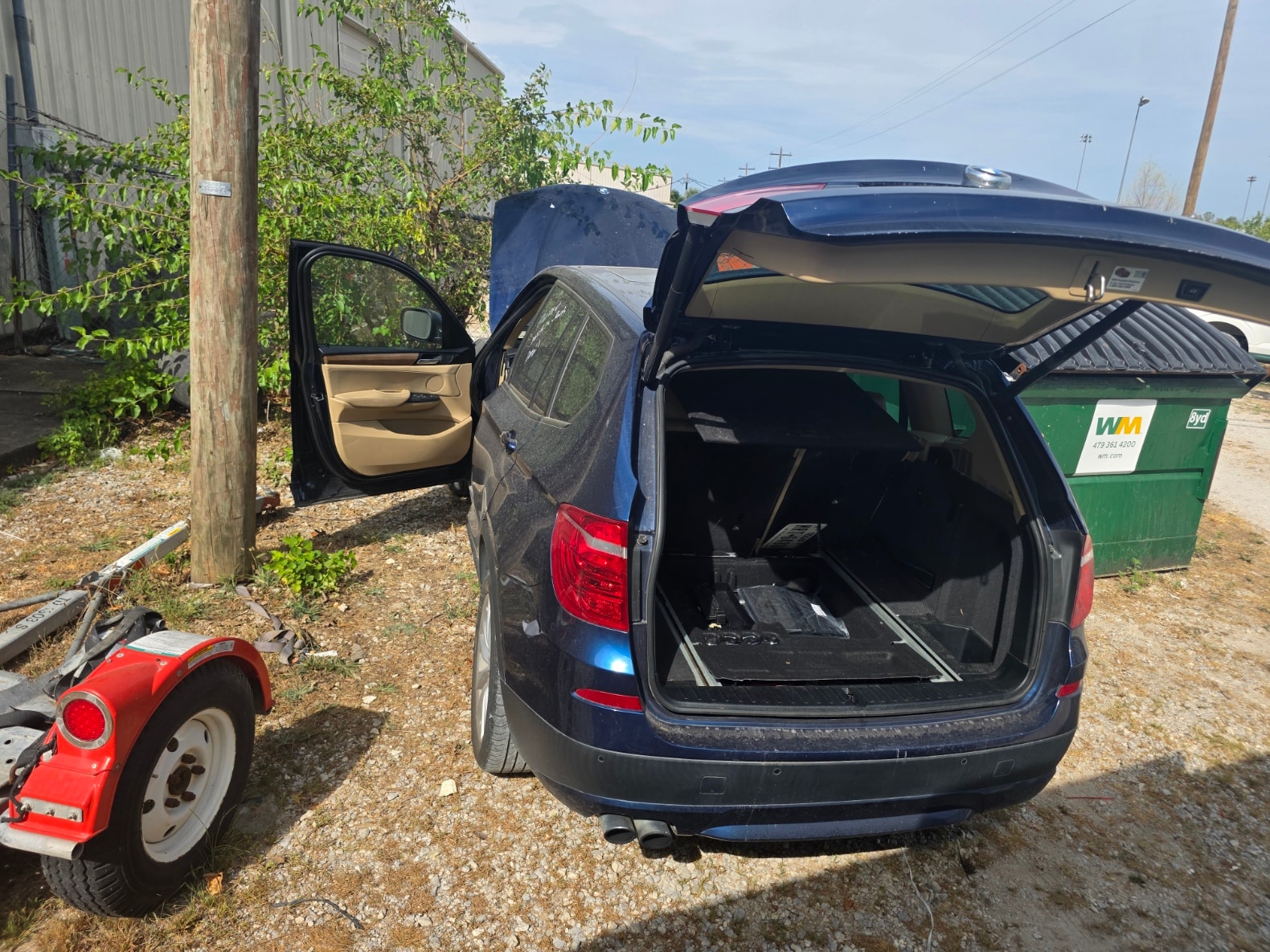 Blue SUV with open hatch