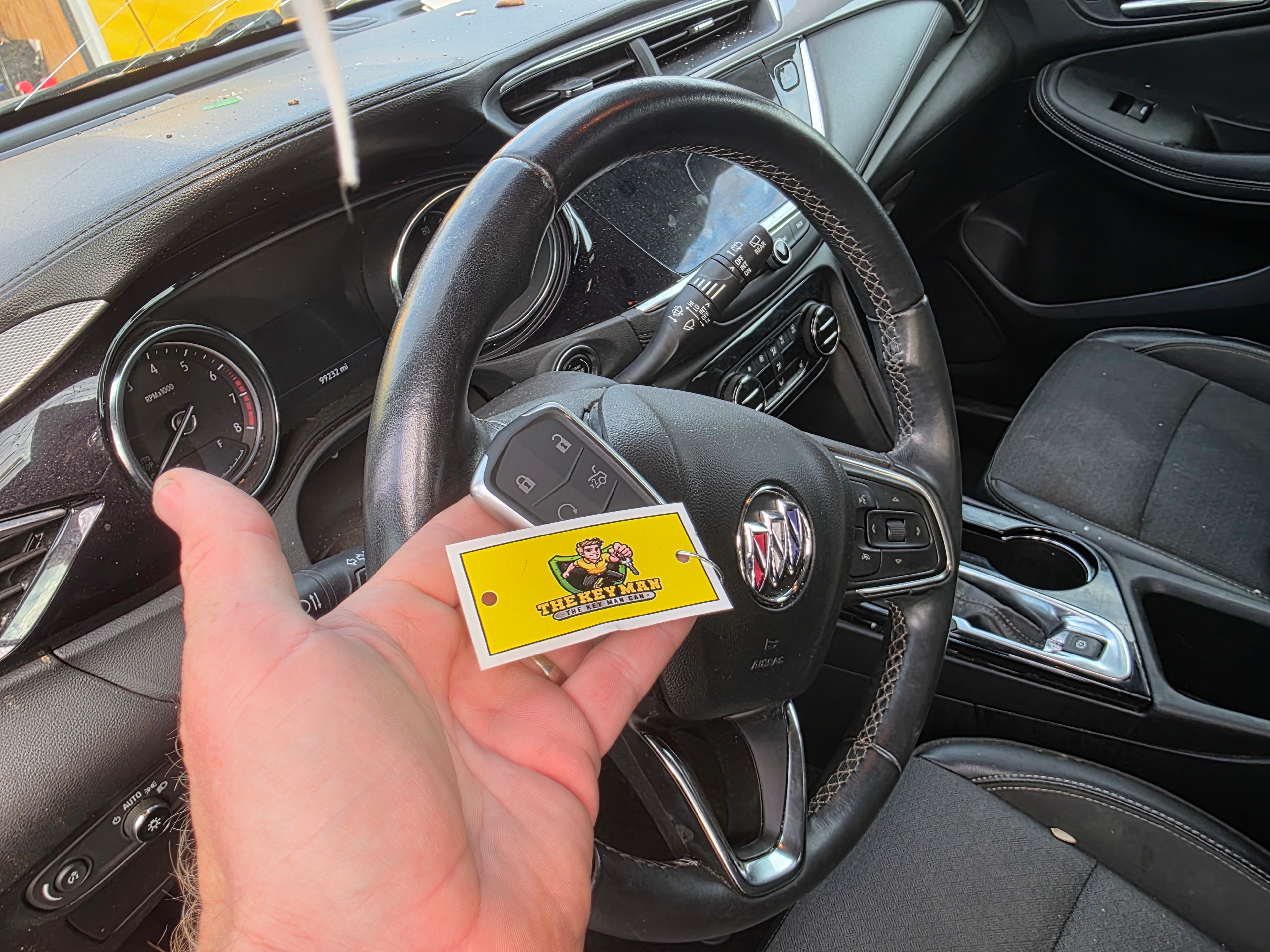 Hand holding sticker in car