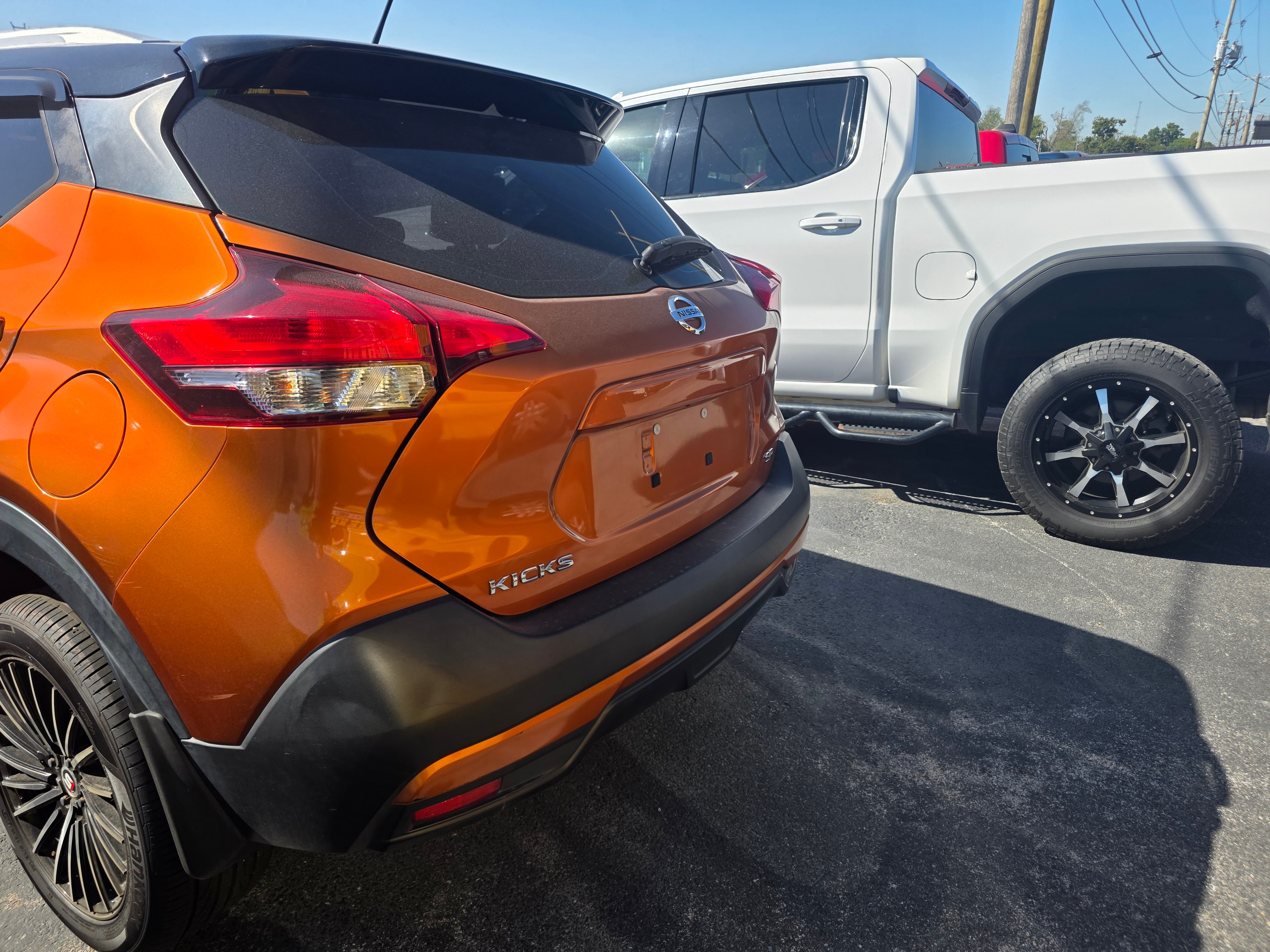 Orange Nissan Kicks in lot